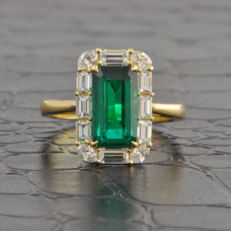 flow-shaped ruby ring-Elongated Emerald and Diamond Halo Ring in Yellow Gold